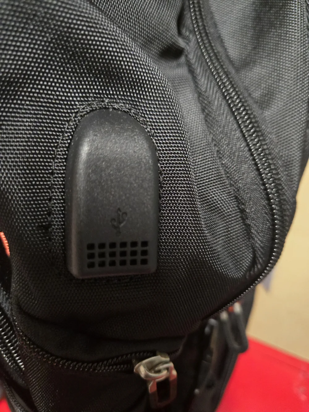 SHRRADOO travel backpack features vibrant red accents on the zippers and strap.